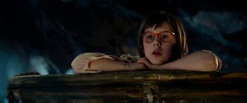 Movie still from “The BFG” (2016), directed by Steven Spielberg – A little girl wearing glasses leaning on a trunk; Close Up shot, Low angle