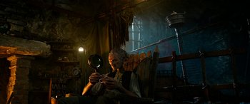 Movie still from “The BFG” (2016), directed by Steven Spielberg – An old man sitting in a chair looking at a mirror; Medium shot, Low angle