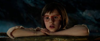 Movie still from “The BFG” (2016), directed by Steven Spielberg – A young girl wearing glasses leaning on a table; Close Up shot, Low angle