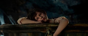 Movie still from “The BFG” (2016), directed by Steven Spielberg – A young girl is leaning on a wooden box; Close Up shot, High angle