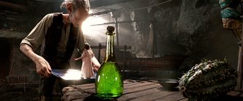 Movie still from “The BFG” (2016), directed by Steven Spielberg – An old man looking at an empty wine bottle; Close Up shot, Over the shoulder angle