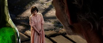 Movie still from “The BFG” (2016), directed by Steven Spielberg – A young girl in a pink dress looking at an animal; Medium shot, Over the shoulder angle