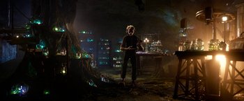 Movie still from “The BFG” (2016), directed by Steven Spielberg – A man standing in a room with lights on the walls; Wide shot, Low angle