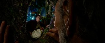 Movie still from “The BFG” (2016), directed by Steven Spielberg – A young girl sitting on the ground next to an animal; Close Up shot, Over the shoulder angle