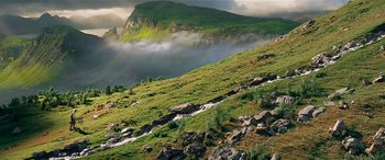 Movie still from “The BFG” (2016), directed by Steven Spielberg – A view of a mountain with a stream running down the side of it; Extreme Wide shot, High angle