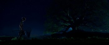 Movie still from “The BFG” (2016), directed by Steven Spielberg – A large tree in a field at night with a sky filled with stars; Extreme Wide shot, Low angle
