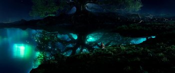 Movie still from “The BFG” (2016), directed by Steven Spielberg – A man sitting on the ground in front of a tree; Extreme Wide shot, High angle