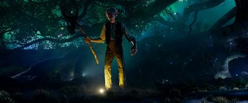 Movie still from “The BFG” (2016), directed by Steven Spielberg – A man standing in the middle of a forest; Wide shot, Low angle