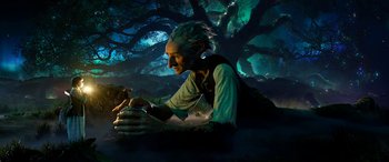 Movie still from “The BFG” (2016), directed by Steven Spielberg – An old man sitting in front of a large tree; Wide shot, Low angle