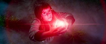Movie still from “The BFG” (2016), directed by Steven Spielberg – A woman holding a light in her hands; Medium shot, Low angle