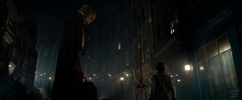 Movie still from “The BFG” (2016), directed by Steven Spielberg – A man and a woman walking down a street at night; Wide shot, Low angle