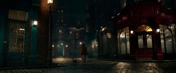 Movie still from “The BFG” (2016), directed by Steven Spielberg – A woman walking a cat down a street at night; Extreme Wide shot, High angle