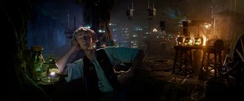 Movie still from “The BFG” (2016), directed by Steven Spielberg – A man standing in the middle of a city at night; Medium shot, Low angle