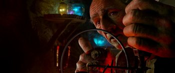Movie still from “The BFG” (2016), directed by Steven Spielberg – An older man holding a wire in his hand; Close Up shot, Low angle