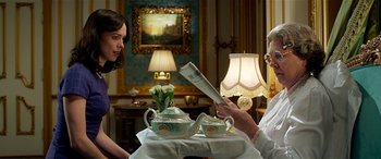 Movie still from “The BFG” (2016), directed by Steven Spielberg – Two people sitting at a table reading a newspaper; Medium shot, Over the shoulder angle