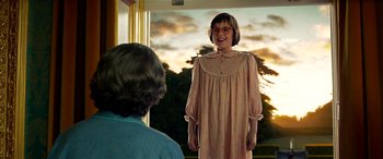 Movie still from “The BFG” (2016), directed by Steven Spielberg – A woman in a nightgown is standing in front of another woman; Medium shot, Low angle