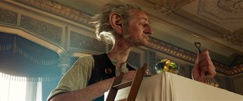 Movie still from “The BFG” (2016), directed by Steven Spielberg – An old man with long white hair is holding a ladder; Medium shot, Low angle