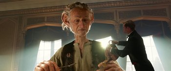 Movie still from “The BFG” (2016), directed by Steven Spielberg – An old man is holding a pair of scissors; Close Up shot, Low angle