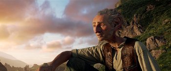 Movie still from “The BFG” (2016), directed by Steven Spielberg – An old man sitting on top of a hill; Close Up shot, Low angle