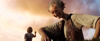 Movie still from “The BFG” (2016), directed by Steven Spielberg – An old man and a little girl in the background; Close Up shot, Low angle