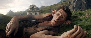 Movie still from “The BFG” (2016), directed by Steven Spielberg – A man laying on the ground in the grass; Medium shot, Low angle