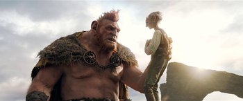 Movie still from “The BFG” (2016), directed by Steven Spielberg – An image of a man and a man with a chain around his neck; Medium shot, Low angle