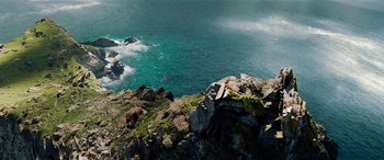 Movie still from “The BFG” (2016), directed by Steven Spielberg – A body of water that has some rocks on it; Extreme Wide shot, High angle