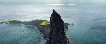 Movie still from “The BFG” (2016), directed by Steven Spielberg – An aerial view of an island in the middle of the ocean; Extreme Wide shot, Low angle