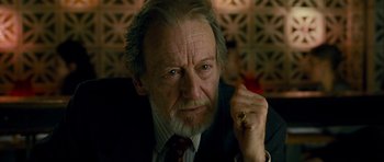 Movie still from “The Best Exotic Marigold Hotel” (2011), directed by John Madden – An older man wearing a suit and tie with a ring on his finger; Close Up shot, Low angle