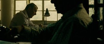 Movie still from “The Best Exotic Marigold Hotel” (2011), directed by John Madden – Two men sitting in front of a window writing on papers; Close Up shot, Over the shoulder angle