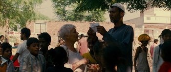 Movie still from “The Best Exotic Marigold Hotel” (2011), directed by John Madden – An older woman and a younger man eating food; Medium shot, High angle