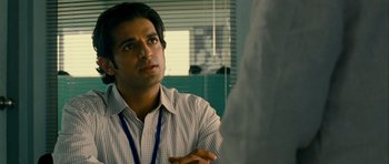 Movie still from “The Best Exotic Marigold Hotel” (2011), directed by John Madden – A man talking to someone in an office setting; Close Up shot, Over the shoulder angle