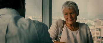 Movie still from “The Best Exotic Marigold Hotel” (2011), directed by John Madden – An older woman sitting in front of a large window; Close Up shot, Over the shoulder angle