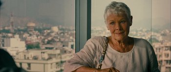 Movie still from “The Best Exotic Marigold Hotel” (2011), directed by John Madden – An older woman sitting in front of a large window; Close Up shot, Over the shoulder angle