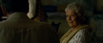 Movie still from “The Best Exotic Marigold Hotel” (2011), directed by John Madden – An older woman is smiling for the camera; Close Up shot, Over the shoulder angle