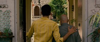 Movie still from “The Best Exotic Marigold Hotel” (2011), directed by John Madden – A couple of men standing next to each other outside; Medium shot, Over the shoulder angle