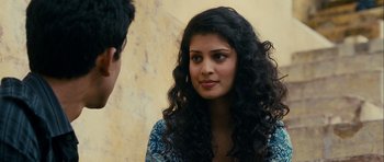 Movie still from “The Best Exotic Marigold Hotel” (2011), directed by John Madden – A woman with long black curly hair talking to a man; Close Up shot, Over the shoulder angle