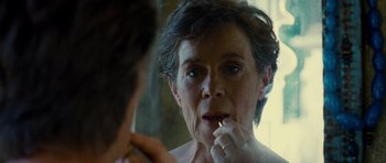 Movie still from “The Best Exotic Marigold Hotel” (2011), directed by John Madden – An older woman brushing her teeth in the mirror; Close Up shot, Over the shoulder angle