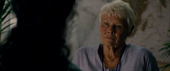 Movie still from “The Best Exotic Marigold Hotel” (2011), directed by John Madden – An older woman is looking at the camera; Close Up shot, Over the shoulder angle