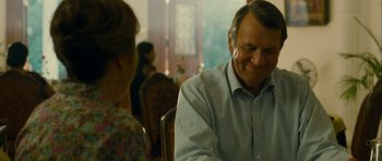 Movie still from “The Best Exotic Marigold Hotel” (2011), directed by John Madden – An older man sitting in front of an older woman; Close Up shot, Over the shoulder angle