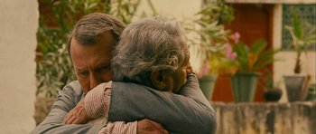 Movie still from “The Best Exotic Marigold Hotel” (2011), directed by John Madden – An older man is hugging a younger man; Close Up shot, Over the shoulder angle