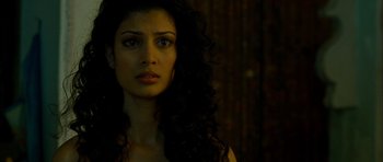 Movie still from “The Best Exotic Marigold Hotel” (2011), directed by John Madden – A beautiful woman with long curly black hair; Close Up shot, Over the shoulder angle
