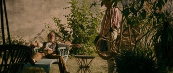 Movie still from “The Best Exotic Marigold Hotel” (2011), directed by John Madden – A man sitting on a chair next to a woman; Wide shot, Low angle