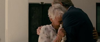 Movie still from “The Best Exotic Marigold Hotel” (2011), directed by John Madden – An older woman hugging a younger man in a room; Close Up shot, Over the shoulder angle