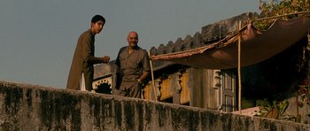 Movie still from “The Best Exotic Marigold Hotel” (2011), directed by John Madden – Two men standing next to each other on a wall; Medium shot, Low angle