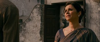 Movie still from “The Best Exotic Marigold Hotel” (2011), directed by John Madden – A woman standing in front of an old building; Close Up shot, Low angle