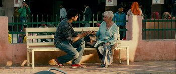 Movie still from “The Best Exotic Marigold Hotel” (2011), directed by John Madden – A man and a woman sitting on top of a wooden bench; Medium shot, Over the shoulder angle