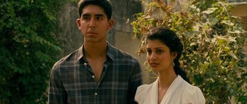 Movie still from “The Best Exotic Marigold Hotel” (2011), directed by John Madden – A man and a woman standing next to each other in front of a tree; Close Up shot, Low angle