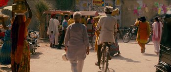 Movie still from “The Best Exotic Marigold Hotel” (2011), directed by John Madden – Two women walking down the street with a bicycle; Wide shot, Over the shoulder angle