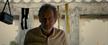 Movie still from “The Best Exotic Marigold Hotel” (2011), directed by John Madden – An older man standing next to a string of pasta; Close Up shot, Low angle